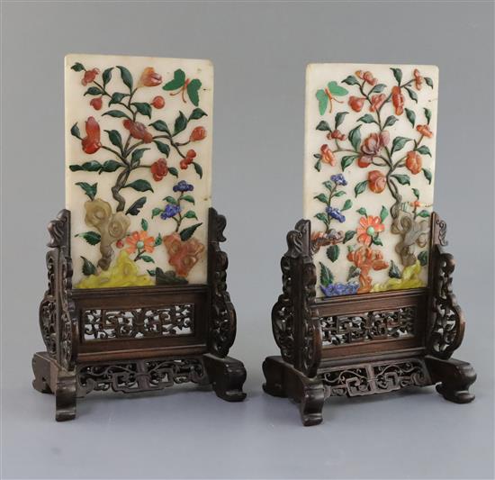 A pair of Chinese hardstone and coral table screens with hongmu stands, early 20th century, Total height 27cm